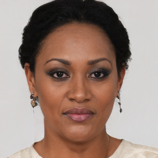 Joyful black adult female with short  black hair and brown eyes