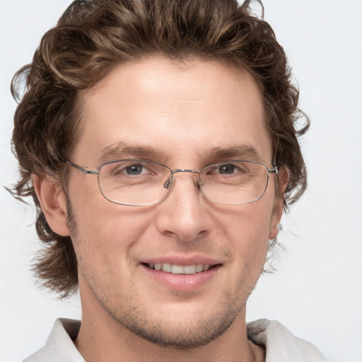 Joyful white adult male with short  brown hair and blue eyes