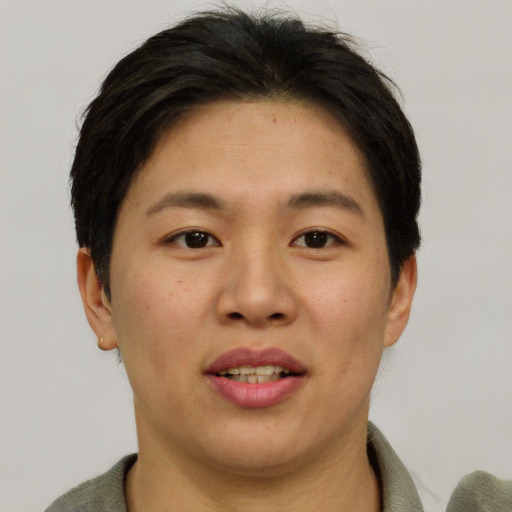 Joyful asian young-adult female with short  brown hair and brown eyes