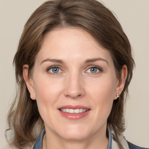 Joyful white adult female with medium  brown hair and grey eyes