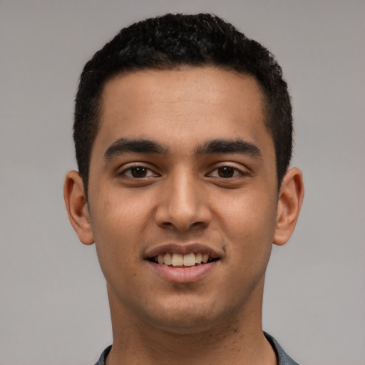 Joyful latino young-adult male with short  black hair and brown eyes