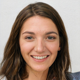 Joyful white young-adult female with long  brown hair and green eyes