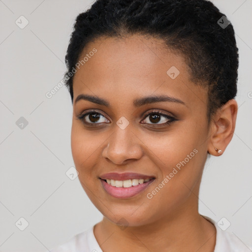 Joyful black young-adult female with short  brown hair and brown eyes