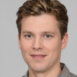 Joyful white adult male with short  brown hair and grey eyes