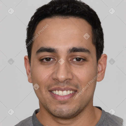 Joyful white young-adult male with short  black hair and brown eyes