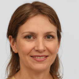 Joyful white adult female with medium  brown hair and grey eyes