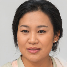 Joyful asian young-adult female with medium  brown hair and brown eyes