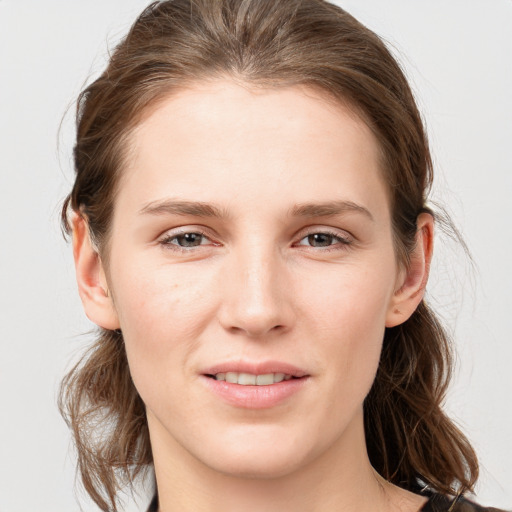 Joyful white young-adult female with long  brown hair and grey eyes