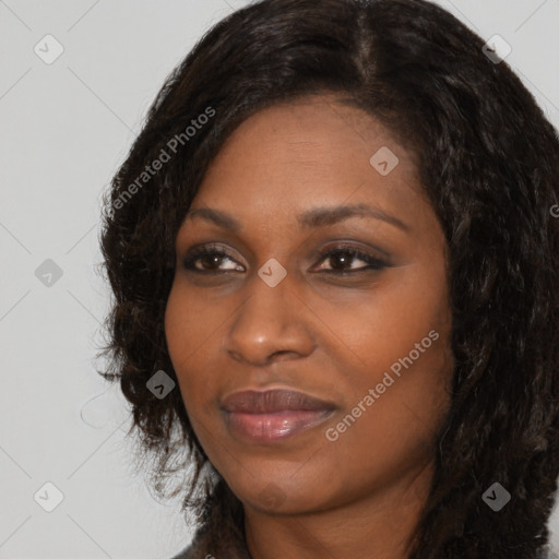 Joyful black young-adult female with long  black hair and brown eyes