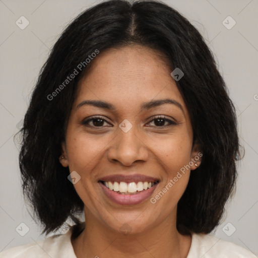 Joyful black adult female with medium  brown hair and brown eyes