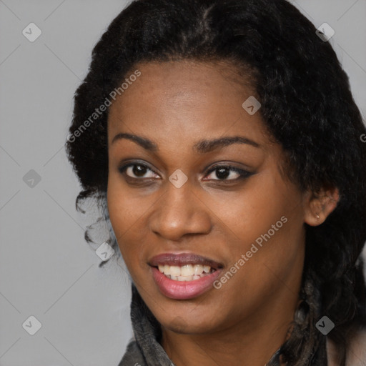 Joyful black young-adult female with long  black hair and brown eyes