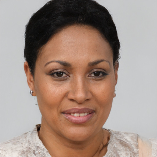 Joyful latino young-adult female with short  brown hair and brown eyes
