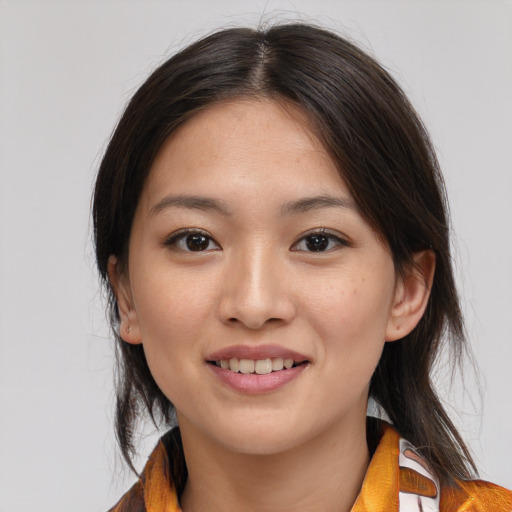 Joyful asian young-adult female with medium  brown hair and brown eyes