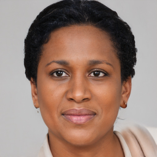Joyful latino adult female with short  black hair and brown eyes