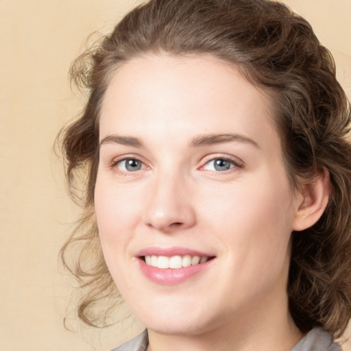 Joyful white young-adult female with medium  brown hair and green eyes