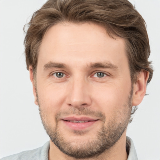 Joyful white adult male with short  brown hair and brown eyes