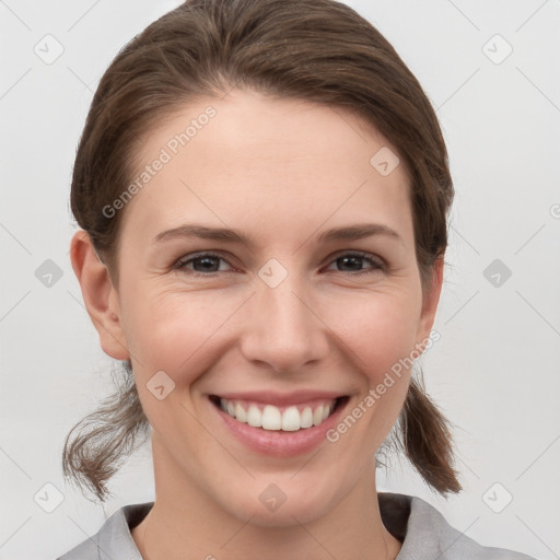 Joyful white young-adult female with medium  brown hair and grey eyes