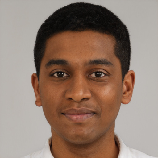 Joyful black young-adult male with short  black hair and brown eyes