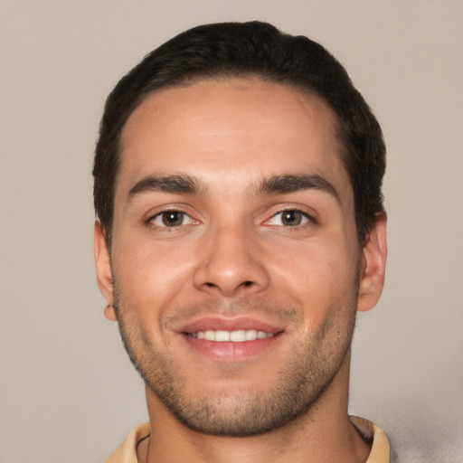 Joyful white young-adult male with short  brown hair and brown eyes