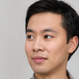 Joyful white young-adult male with short  black hair and brown eyes