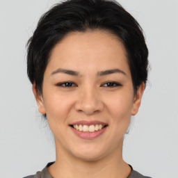 Joyful asian young-adult female with medium  brown hair and brown eyes