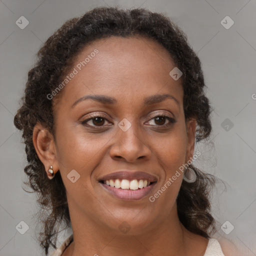 Joyful black adult female with medium  brown hair and brown eyes