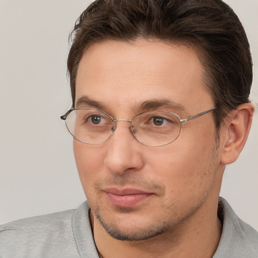 Joyful white adult male with short  brown hair and brown eyes