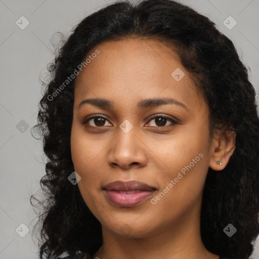 Joyful black young-adult female with long  black hair and brown eyes