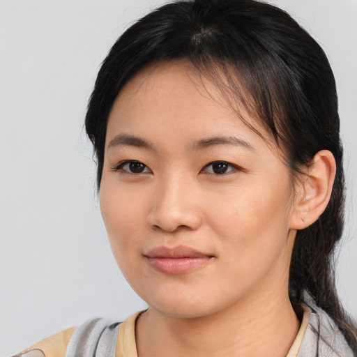 Joyful asian young-adult female with medium  black hair and brown eyes