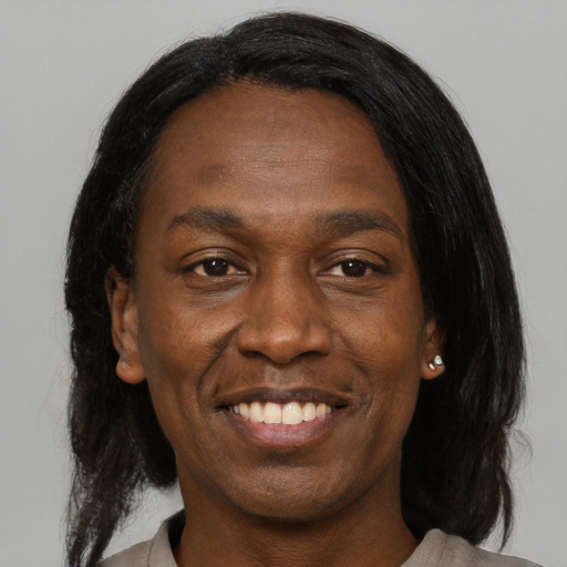 Joyful black adult male with medium  black hair and brown eyes