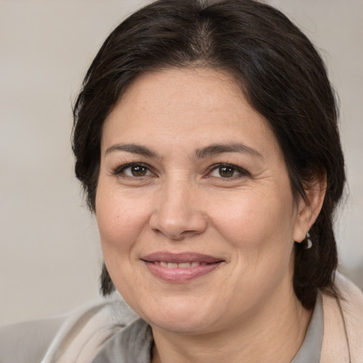 Joyful white adult female with medium  brown hair and brown eyes