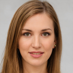 Joyful white young-adult female with long  brown hair and green eyes