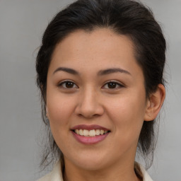 Joyful latino young-adult female with medium  brown hair and brown eyes