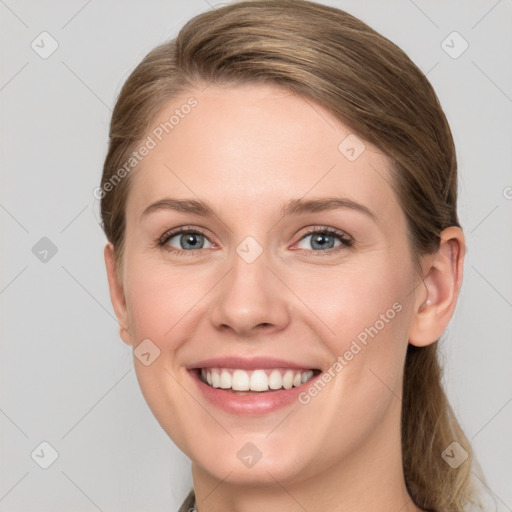 Joyful white young-adult female with long  brown hair and blue eyes