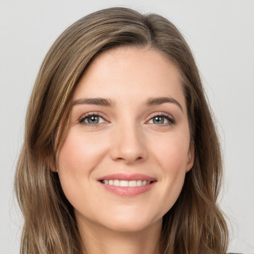 Joyful white young-adult female with long  brown hair and grey eyes