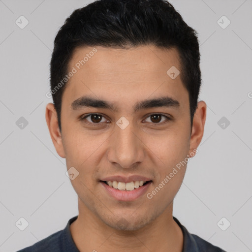 Joyful white young-adult male with short  black hair and brown eyes