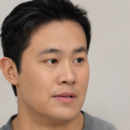 Neutral asian young-adult male with short  brown hair and brown eyes