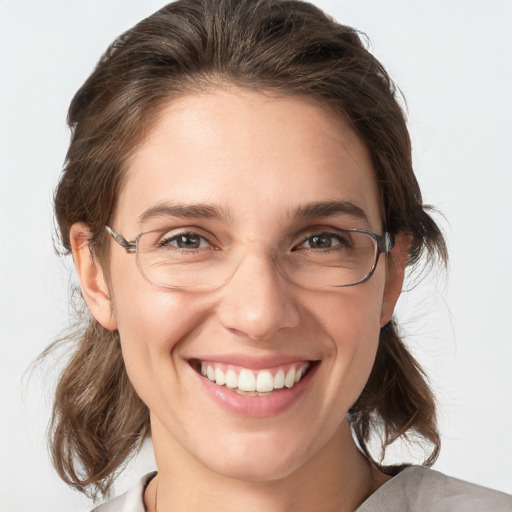 Joyful white adult female with medium  brown hair and grey eyes