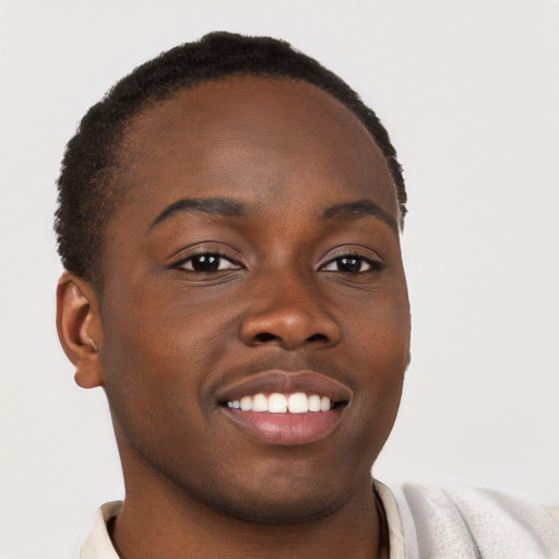 Joyful black young-adult male with short  brown hair and brown eyes