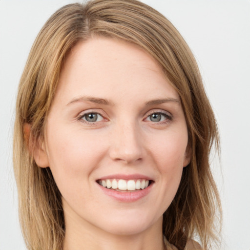 Joyful white young-adult female with long  brown hair and green eyes