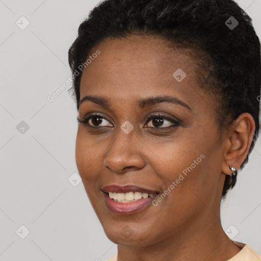 Joyful black young-adult female with short  black hair and brown eyes