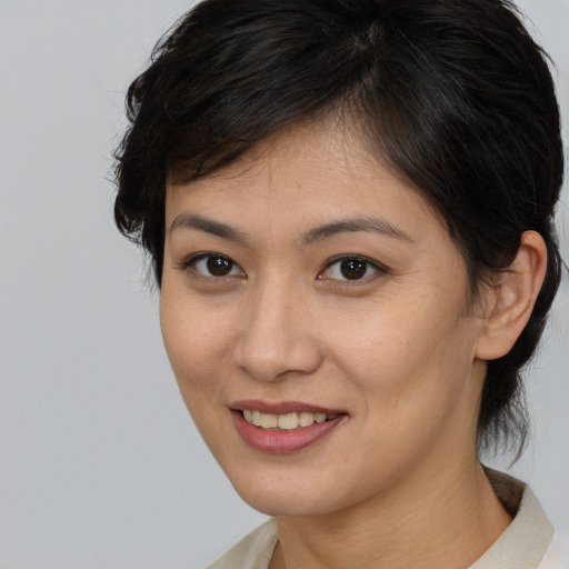 Joyful asian young-adult female with medium  brown hair and brown eyes