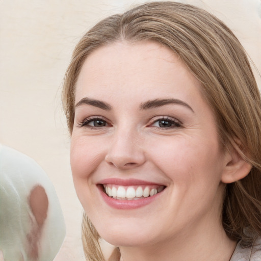 Joyful white young-adult female with long  brown hair and grey eyes