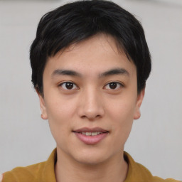 Joyful asian young-adult male with short  black hair and brown eyes