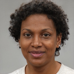 Joyful black adult female with short  brown hair and brown eyes