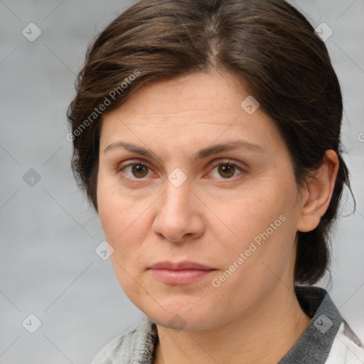 Joyful white adult female with medium  brown hair and grey eyes