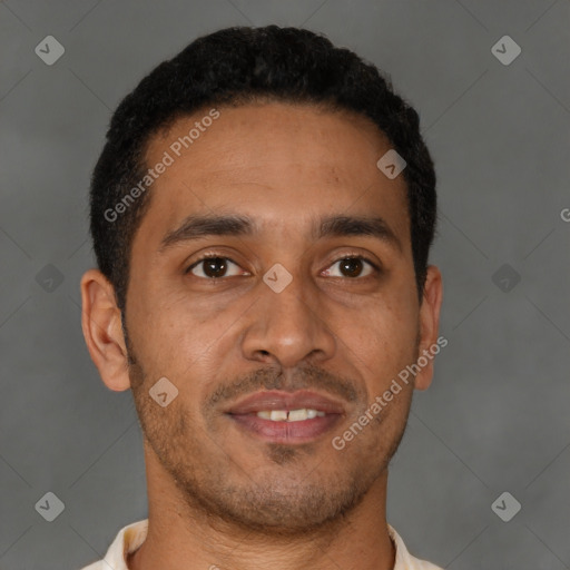 Joyful latino young-adult male with short  brown hair and brown eyes