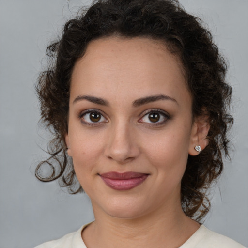 Joyful white young-adult female with medium  brown hair and brown eyes