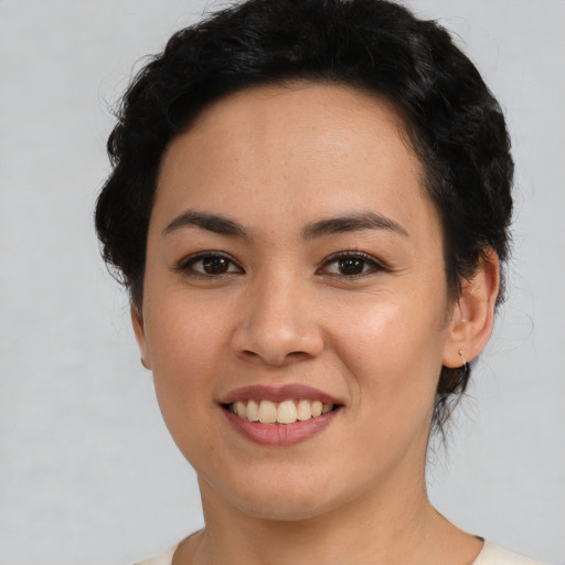 Joyful asian young-adult female with short  black hair and brown eyes