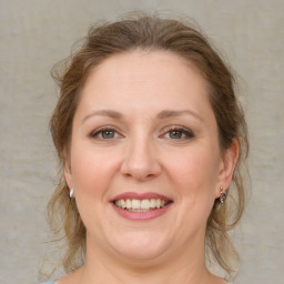 Joyful white adult female with medium  brown hair and grey eyes